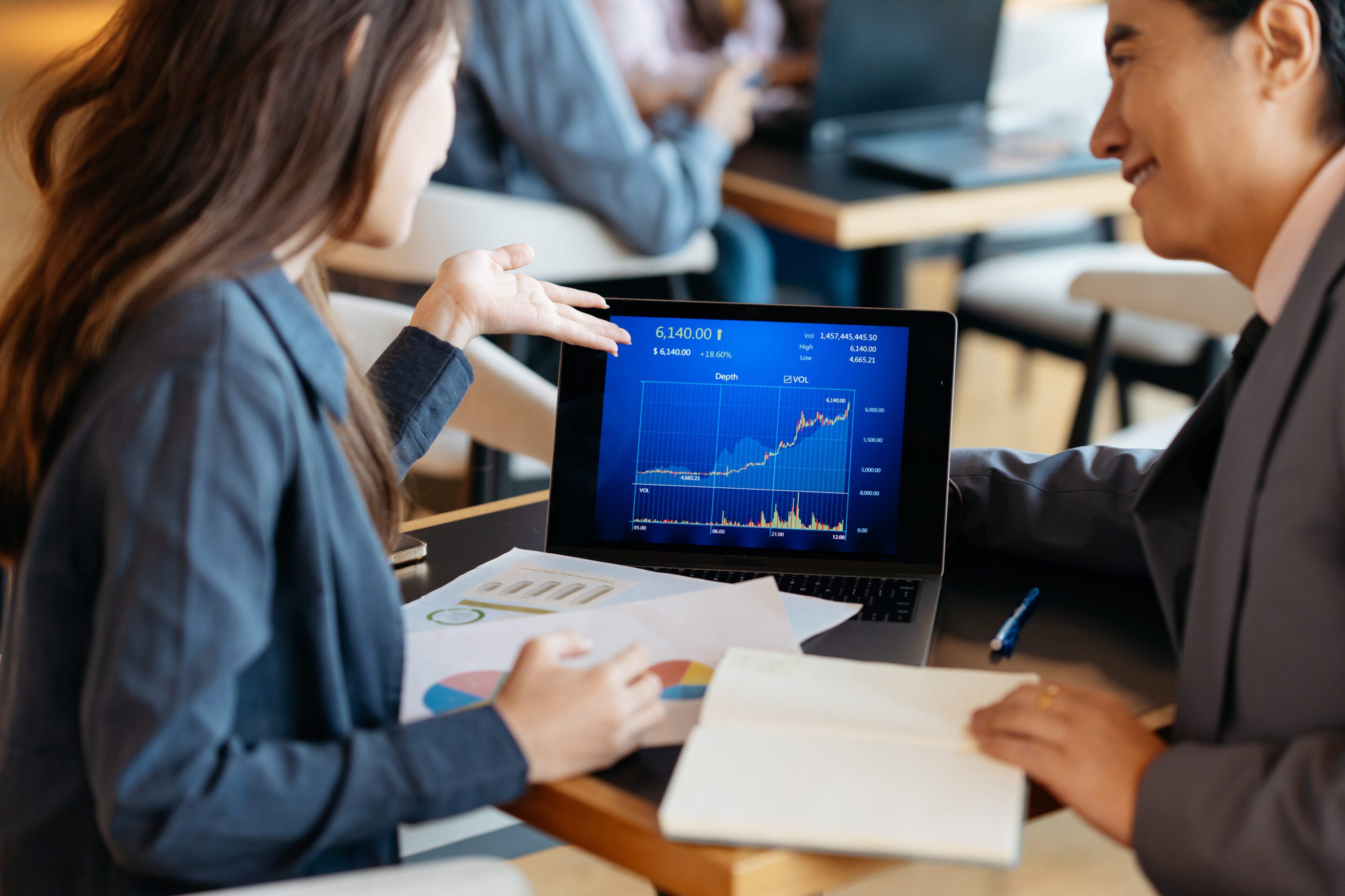 Business meeting with laptop graphs